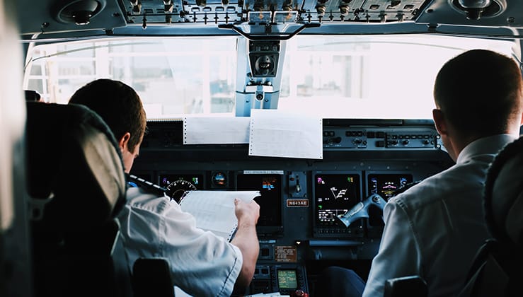 Pilots reviewing documents in an aircraft cockpit